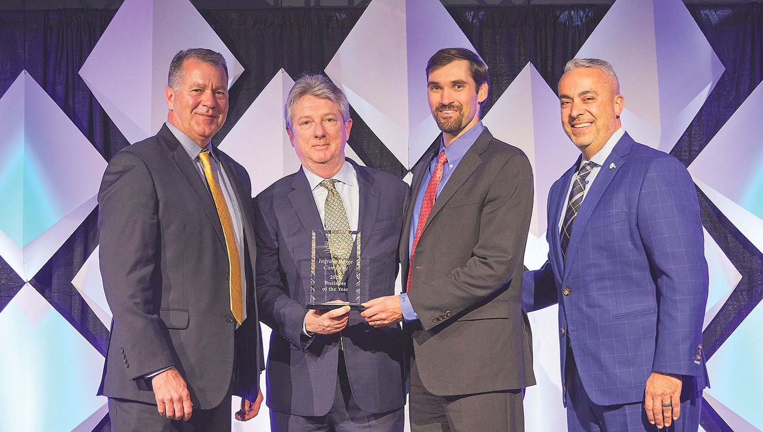 (Left to right) Mike Yungmann, representing event sponsor Mercy Health; John Roberts, Ingram Barge Company president and CEO; Aaron Barrett, Ingram chief operations officer and great grandson of the founder; and 2023 Paducah Chamber Board Chair Brent Housman. (photo by Brad Rankin Photography and courtesy of the Paducah Area Chamber of Commerce)