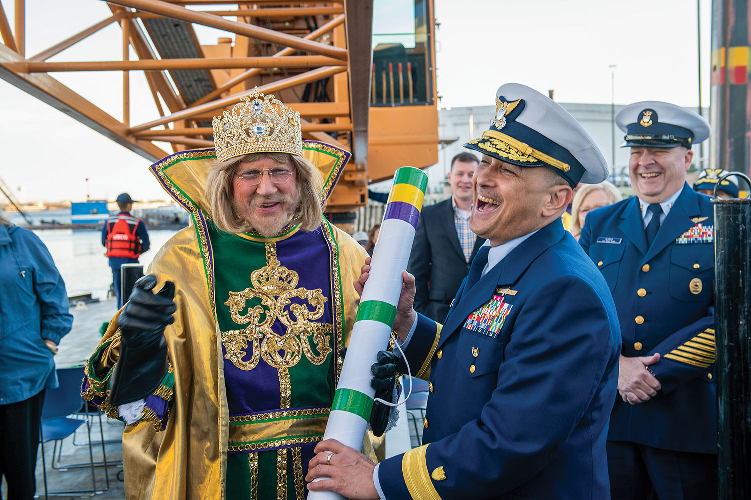 His Majesty the King of Carnival, John Eastman, presents a royal decree of appreciation to Rear Adm. David Barata, commander of the Eighth Coast Guard District, aboard the cutter Pamlico on February 12, known as “Lundi Gras” in New Orleans. (Photo courtesy of U.S. Coast Guard)