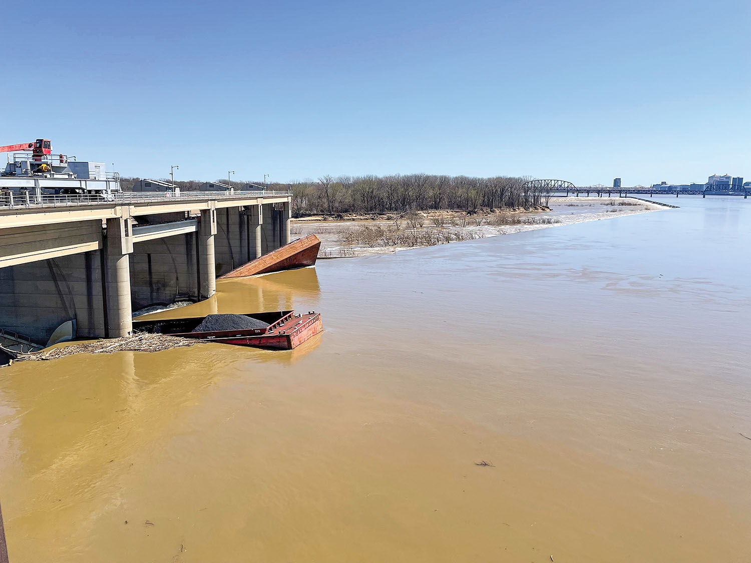 Two barges were initially in the gate bays at McAlpine Locks and Dam, Ohio Mile 606.8, following a 10-barge breakaway, as seen in this March 11 photo. One of those flushed through the gate the next day and sank about 400 feet below the site. (Photo courtesy of Louisville Engineer District)