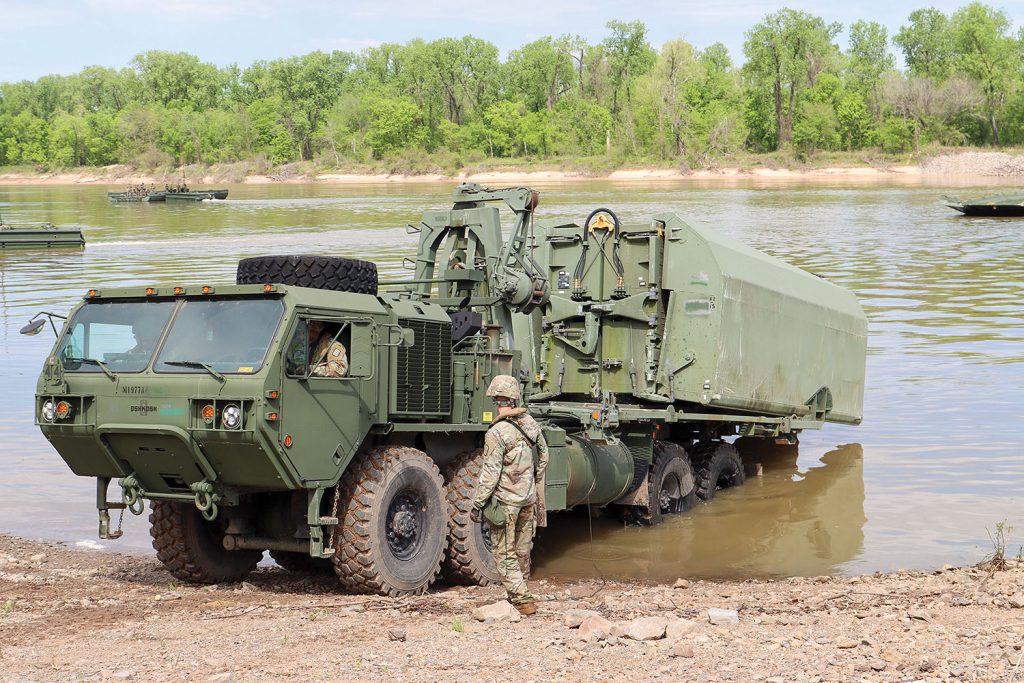 Army units perform a river assault and bridge-building exercise on the Arkansas River April 12. (Photos by Jay Woods, Rock Island Engineer District)
