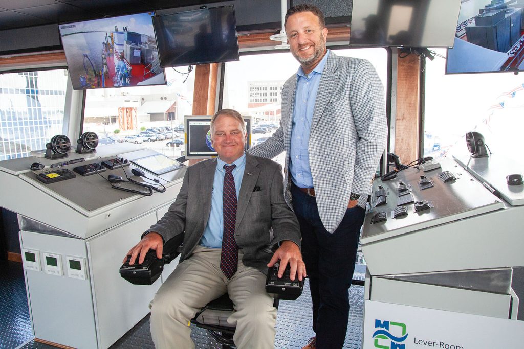 Kenny Devall, CEO of Southern Devall, stands alongside Mike Kerns, president, CEO and co-owner of Muddy Water Dredging, in the lever room aboard the Vaneta Marie. (Photo by Frank McCormack)
