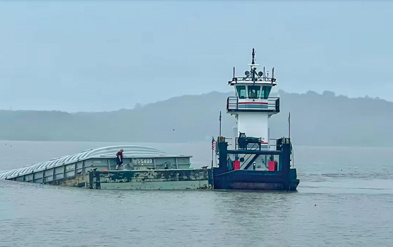 A barge carrying corn sank May 9 following an allision between the tow of the mv. Joe B. Wyatt and the bridge over the Mississippi River between Fort Madison, Iowa, and Niota, Ill. (Photo courtesy of WGEM, Quincy, Ill.)