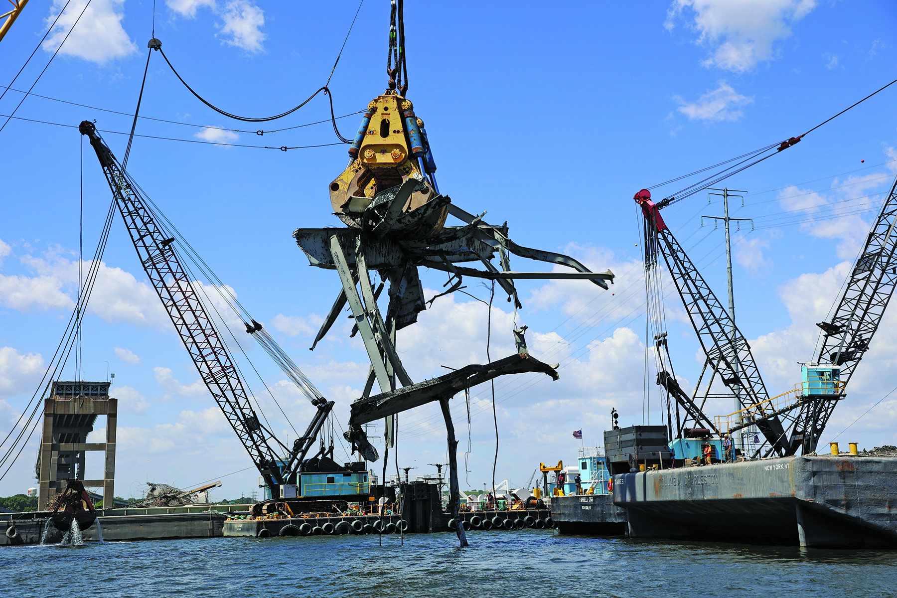 The floating crane Chesapeake 1000 (“Chessy”), equipped with “Gus” the hydraulic grabber, removes a 90-ton piece of the Francis Scott Key bridge from the water June 7 during the multiagency effort to reopen the Fort McHenry Federal Channel to navigation. The channel reopened to navigation June 10. (Photo courtesy of the Baltimore Engineer District)