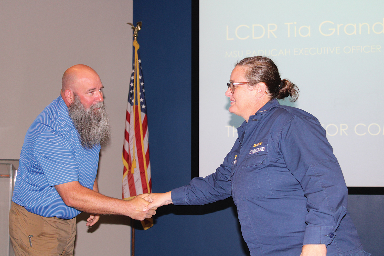 Coast Guard Sector Ohio Valley Commander Heather Mattern presents Josef Vlach (left), vice president of compliance and emergency management with James Marine, with a coin in appreciation for his help with the Marine Safety Unit Paducah Industry Day on October 18. (Photo by Shelley Byrne)