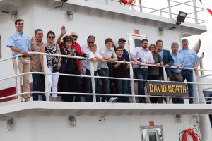 David North (above nameplate) and his wife, Karen, stand on the deck of his namesake vessel, surrounded by friends, family and Ingram colleagues.