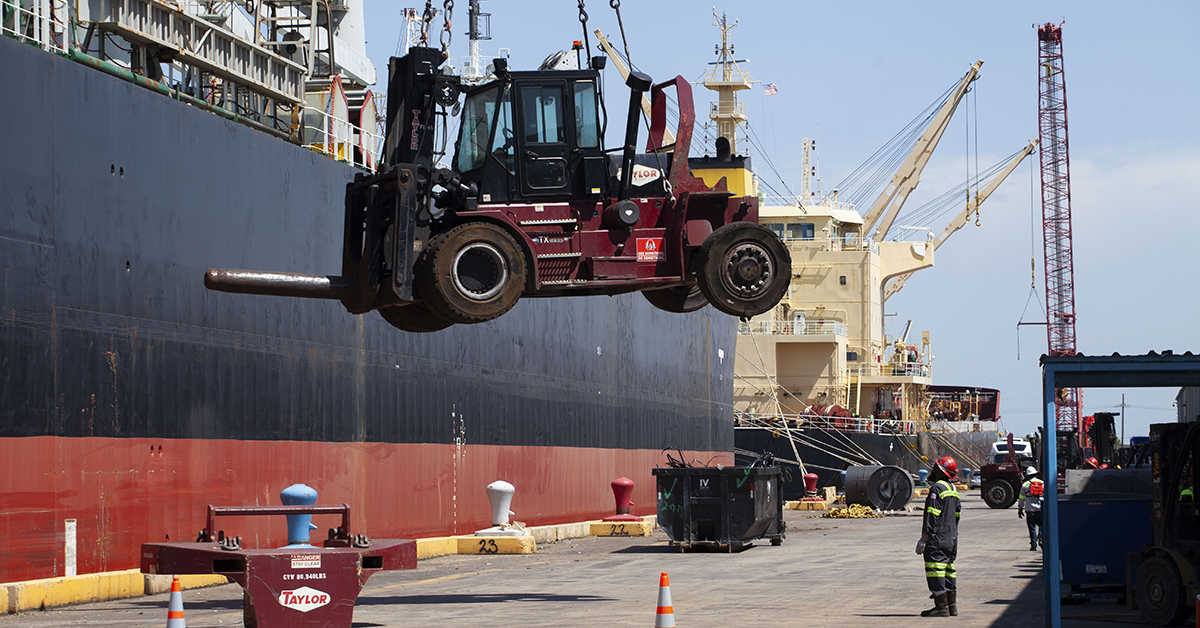 A crane operator lowers a steel coil handler out of a hold aboard the Singapore-flagged cargo ship Asian Summit and onto the dock at the Chalmette Slip. Associated Terminals unloaded the Asian Summit May 15. (Photo by Frank McCormack)