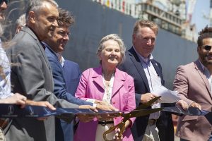 Phylis Scafidel, wife of longtime St. Bernard Port Executive Director Robert J. Scafidel, cuts the ribbon to mark the official completion of rehabilitation efforts at the Chalmette Slip. Scafidel was joined by Drew Heaphy (right), executive director of the port, and Gary Poirrier (left), chairman of Associated Terminals, among others. (Photo by Frank McCormack)