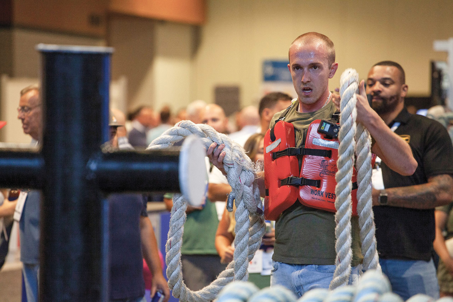 Leighton Loveless, then a steersman with Central Boat Rentals, prepares to throw a line at the Maritime Throwdown final competition at the 2024 Inland Marine Expo (IMX). Loveless came in first place. (Photo by Frank McCormack)