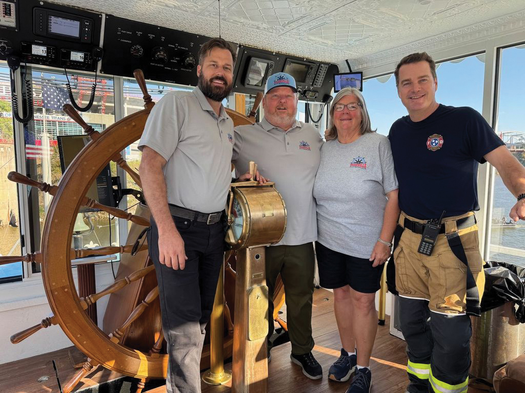 (Left to right) Descendants of Streckfus Steamers founder John Streckfus Sr. (fifth generation) Capt. Brian Bristol, (fifth generation) Capt. Troy Manthey and (fourth generation) Capt. Joy Manthey spend time with Chris O’Donnell, an actor in 9-1-1: Nashville, in the pilothouse of the Capitol during the October filming of an episode featuring the riverboat. The Capitol will begin offering excursions in Nashville, Tenn., in spring 2026, along with the steamboat Nashville. (Photo courtesy of Nashville Riverboats)