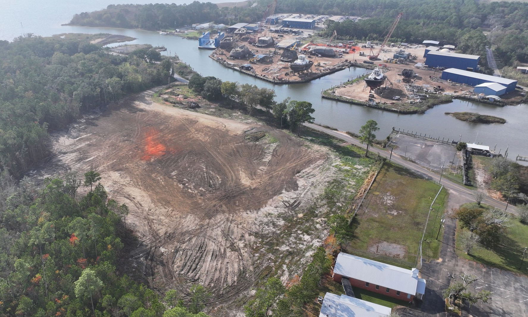 An aerial view of Coden, Ala.-based Master Boat Builders’ forthcoming defense-focused shipyard (foreground) with the company’s existing commercial yard in the background. (Photo courtesy of Master Boat Builders)