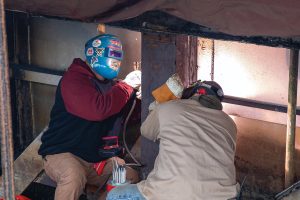Welders from the Little Rock Engineer District work to cut away damaged portions of vertical members from Dardanelle Lock’s upper miter gate and to replace them with undamaged metal. The lock reopened December 3.