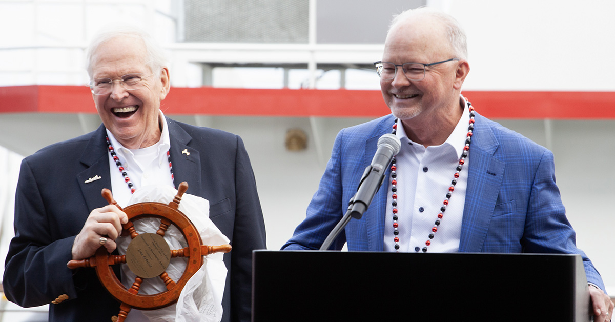 Kurt Strand (right), president and CEO of the National Mississippi River Museum & Aquarium, speaks at the christening of the mv. John Paul Eckstein, held in New Orleans January 10. Strand and Capt. Corky Bickel (left) presented the National Rivers Hall of Fame's National Achievement Award to John Eckstein, executive chairman of Marquette Transportation Company. (Photo by Frank McCormack)