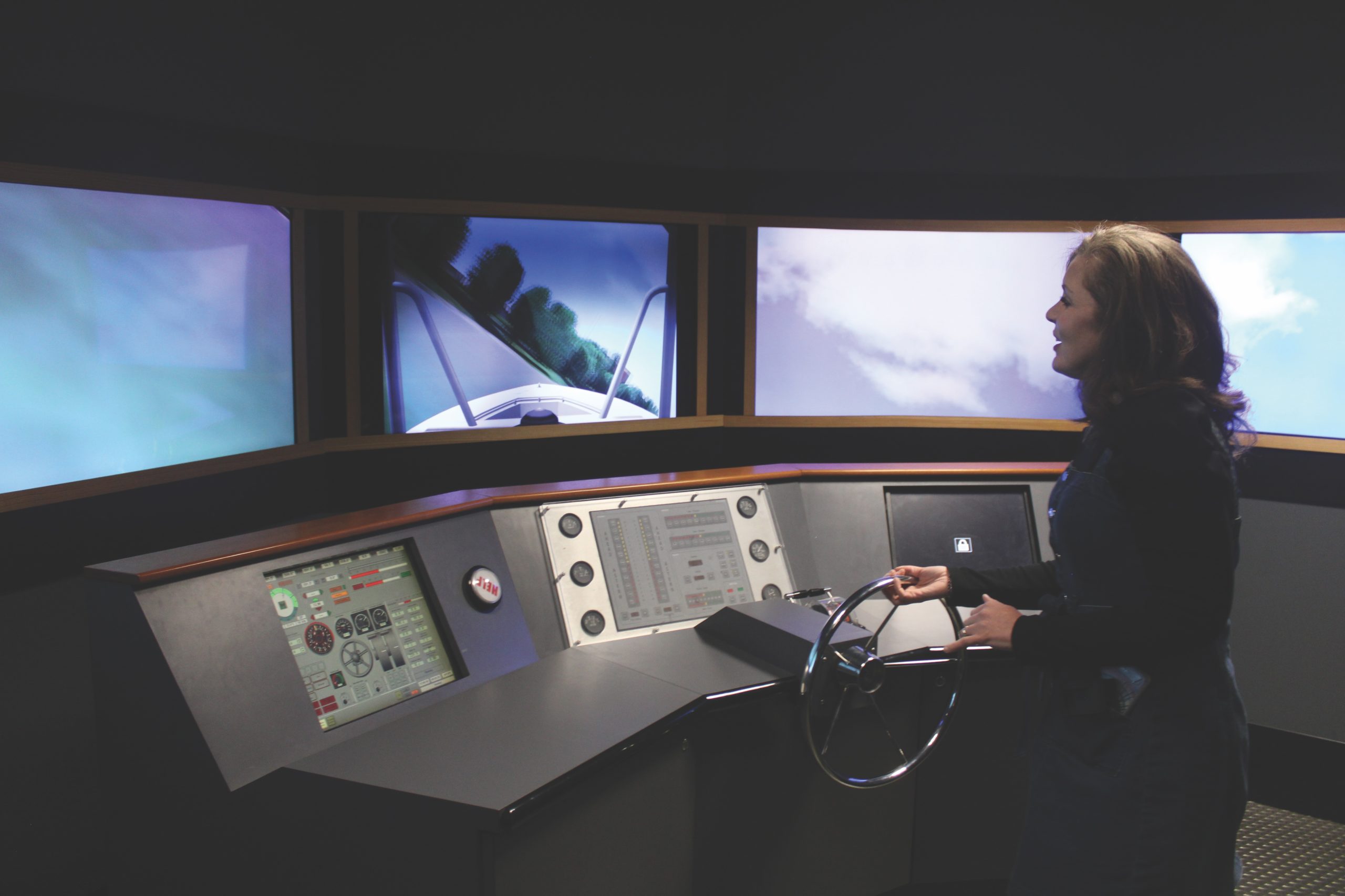 Lindsey Launius, executive director of the River Discovery Center in Paducah, Ky., pilots the center’s boat simulator. The museum is seeking donations of $30,000 or nine slightly-used, high-end gaming computers capable of running $100,000 in donated modern software. (Photo by Shelley Byrne)