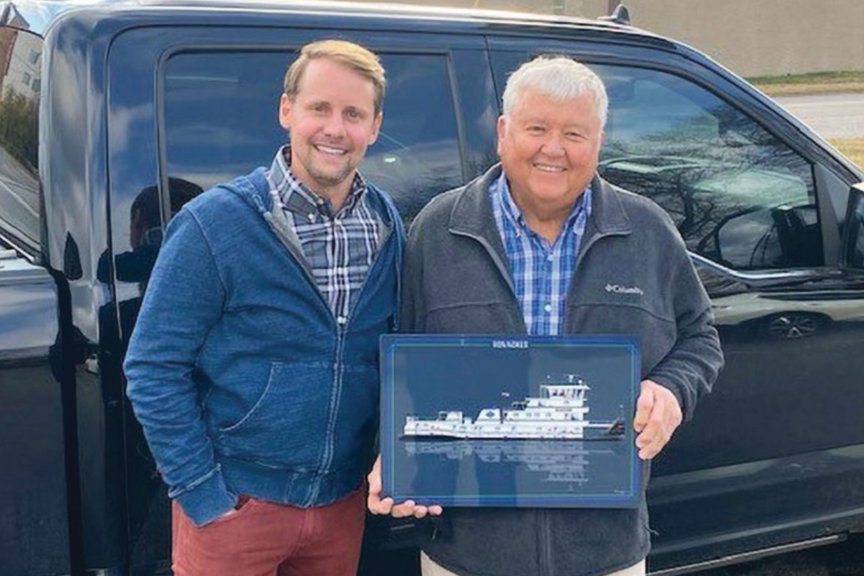 Kent Furlong (left), president and founder of Hines Furlong Line, presents Ron Nokes a plaque of the mv. Ron Nokes. (WJ file photo)