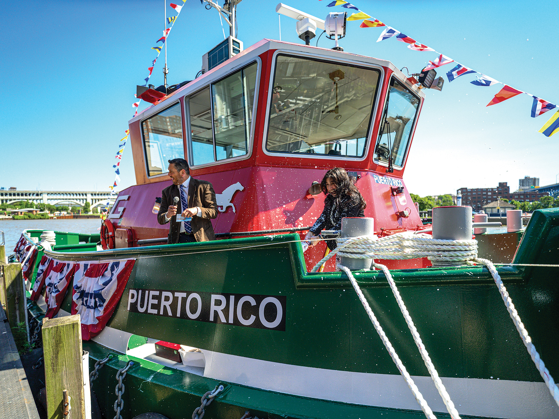 260622_Great Lakes Sara Fuentes, president of the Transportation Institute, breaks a bottle of champagne to christen The Great Lakes Towing Company’s newest tug, Puerto Rico. (Photo courtesy of Great Lakes Towing Company)