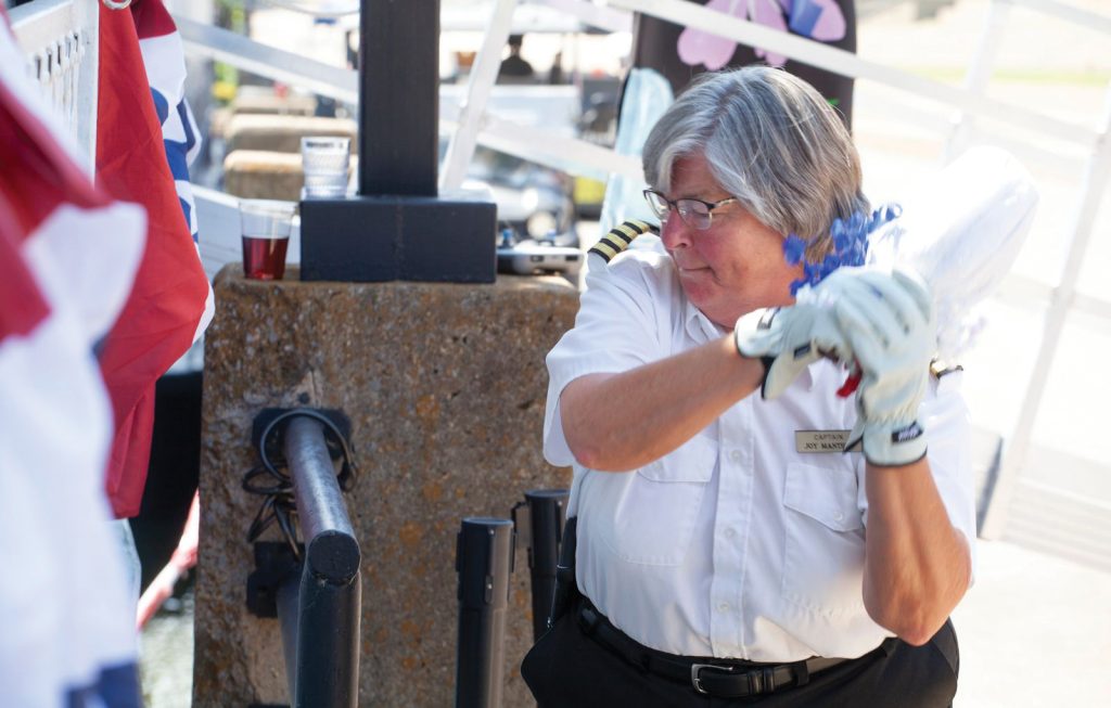 Capt. Joy Manthey breaks a bottle of Tennessee whiskey to christen the Capitol on May 13 in Nashville, Tenn. Manthey is the aunt of Nashville Riverboats President and CEO Troy Manthey, and they share a special relationship.