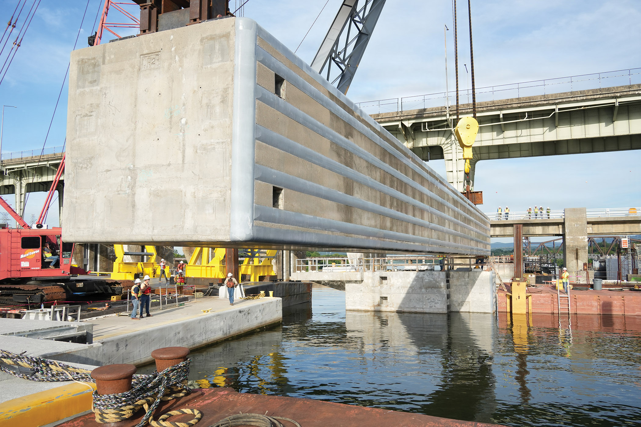 260720_Chickamauga beams2 A 420-ton concrete beam is hoisted into position over the Tennessee River June 16 during construction of the upstream approach wall for the Chickamauga Lock Replacement Project in Chattanooga, Tenn. The successful placement of these massive beams, guided by contractors on the pier below, marks a significant milestone in the project. (Photo by Noe Gonzalez/Nashville Engineer District)