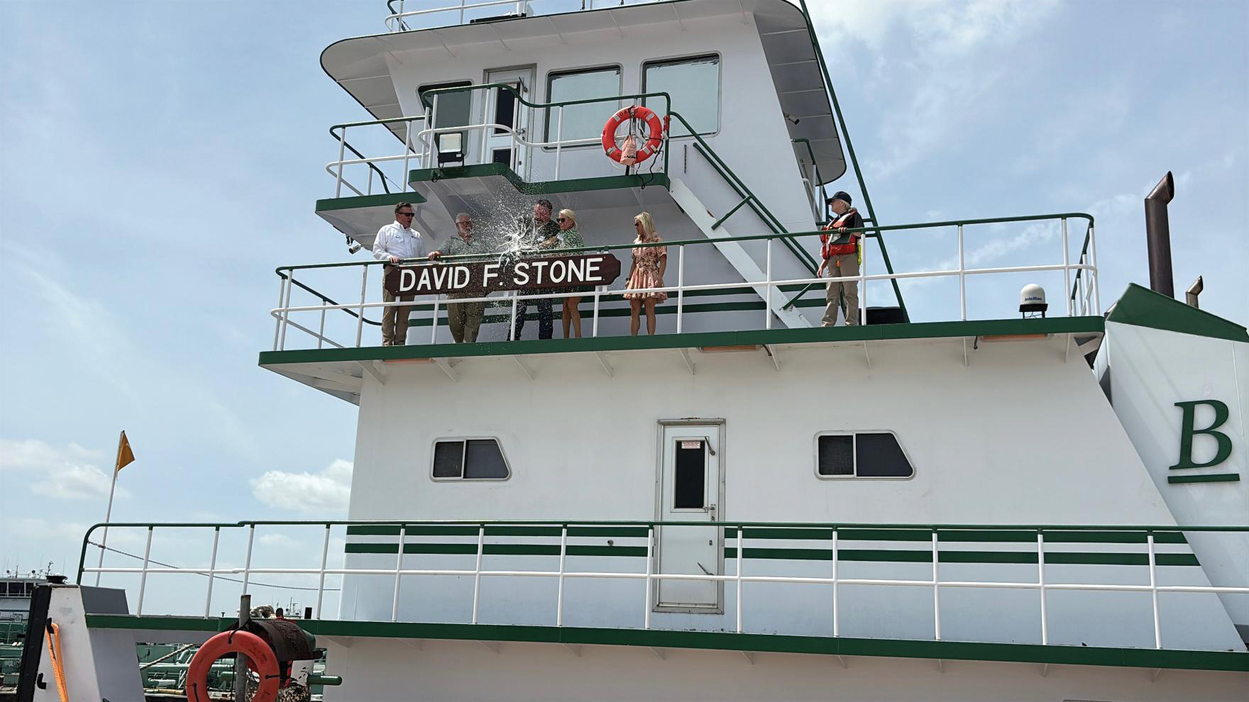 Blessey_image1 Laura Todd and Laney Watkins help to break the bottle across the nameboard of the mv. David F. Stone during the vessel’s christening after the presentation of a Bible by Chaplain Nancy Simpson. (Photos by by Ashley Borocco)