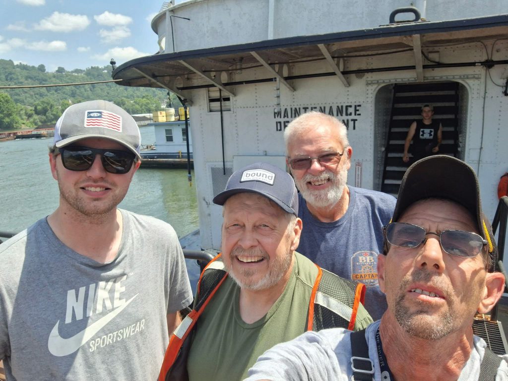 The crew standing in front of the former floating restaurant. Pictured from left to right Capt. Alex Schuchter, Capt. David Smith, Capt. Kerry Snowden and Matthew Newbauer. (Photo by Matthew Newbauer)