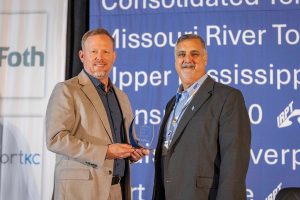 Anthony Gex, right, deputy director of IRPT, presents a 2026 IRPT Cargo Award to Jody Peacock of Ports of Indiana during the inaugural year of the awards program.