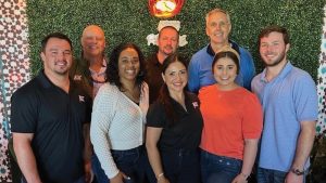 Mike Kennelly, second from left in the back row, poses with members of the ACBL team. (Photo courtesy of ACBL)